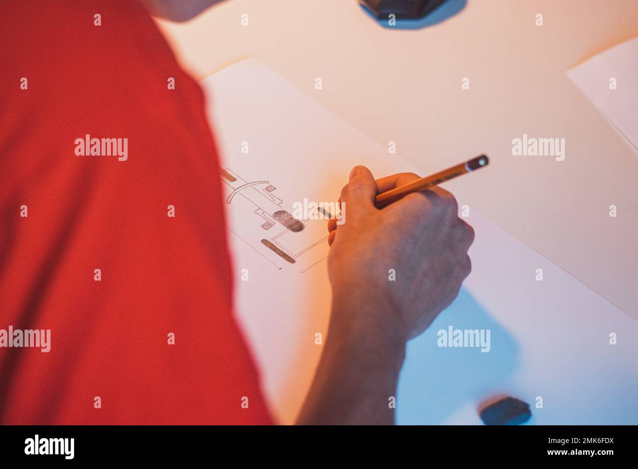 Brown-haired young architect creates new product designs for a new ...