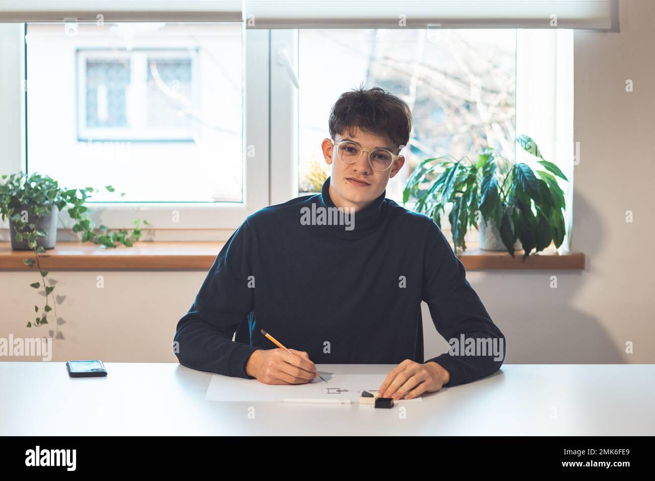 Brown-haired young architect creates new product designs for a new ...