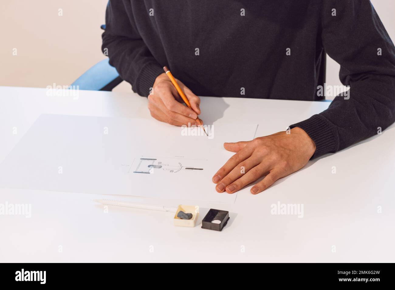 Brown-haired young architect creates new product designs for a new ...