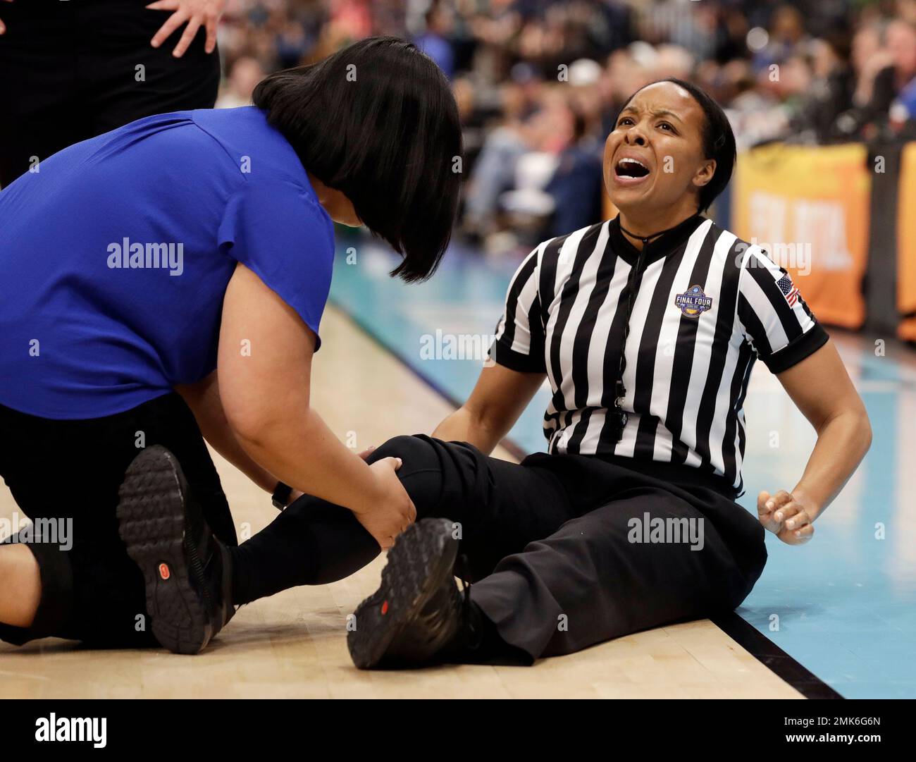 Referee Michol Murray is attended on the court after she injured her
