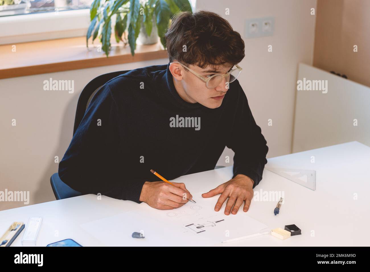 Brown-haired architect creates new product designs for a new futuristic ...