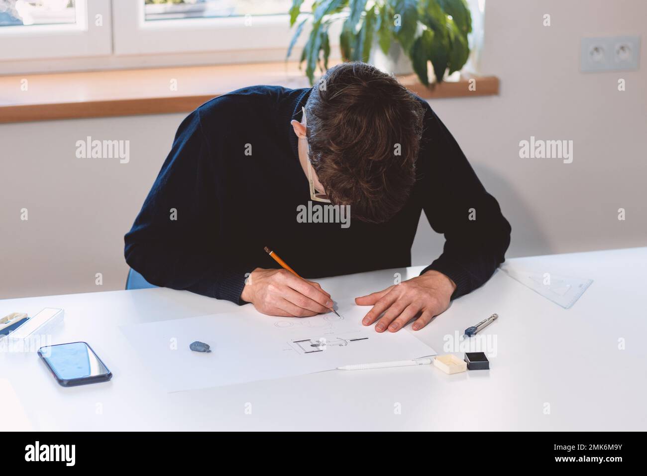 Brown-haired architect creates new product designs for a new futuristic ...