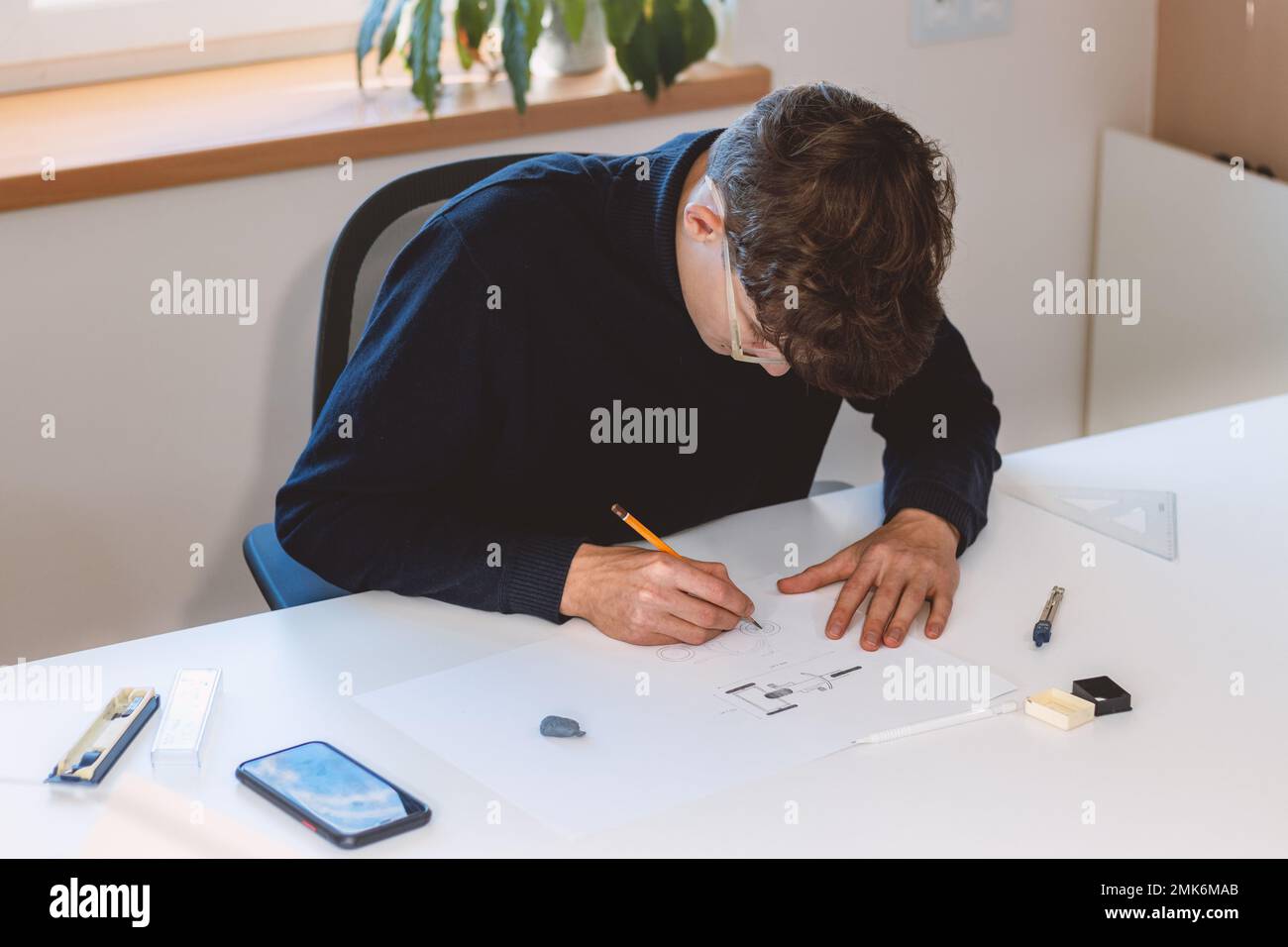 Brown-haired architect creates new product designs for a new futuristic ...