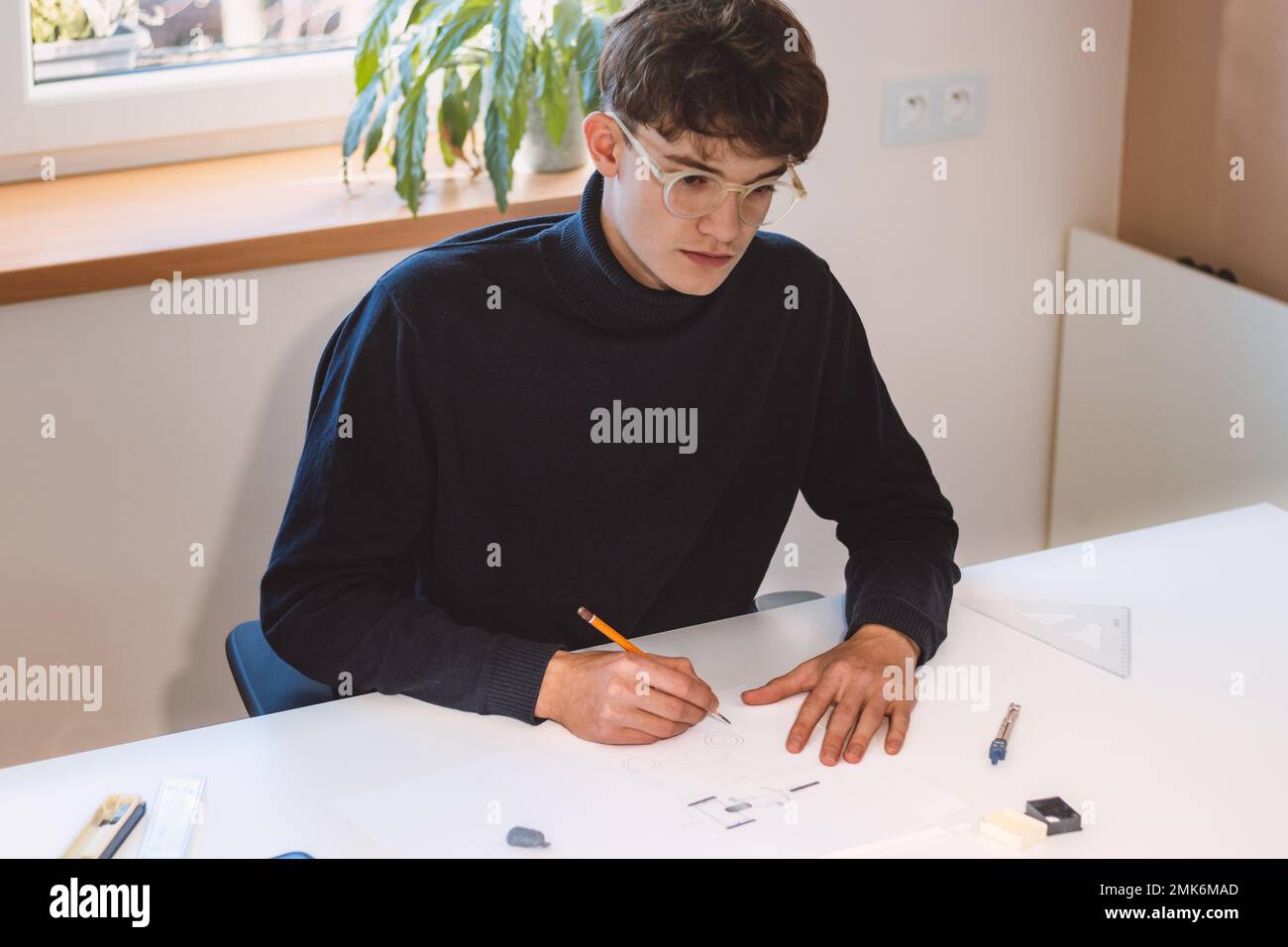 Brown-haired architect creates new product designs for a new futuristic ...