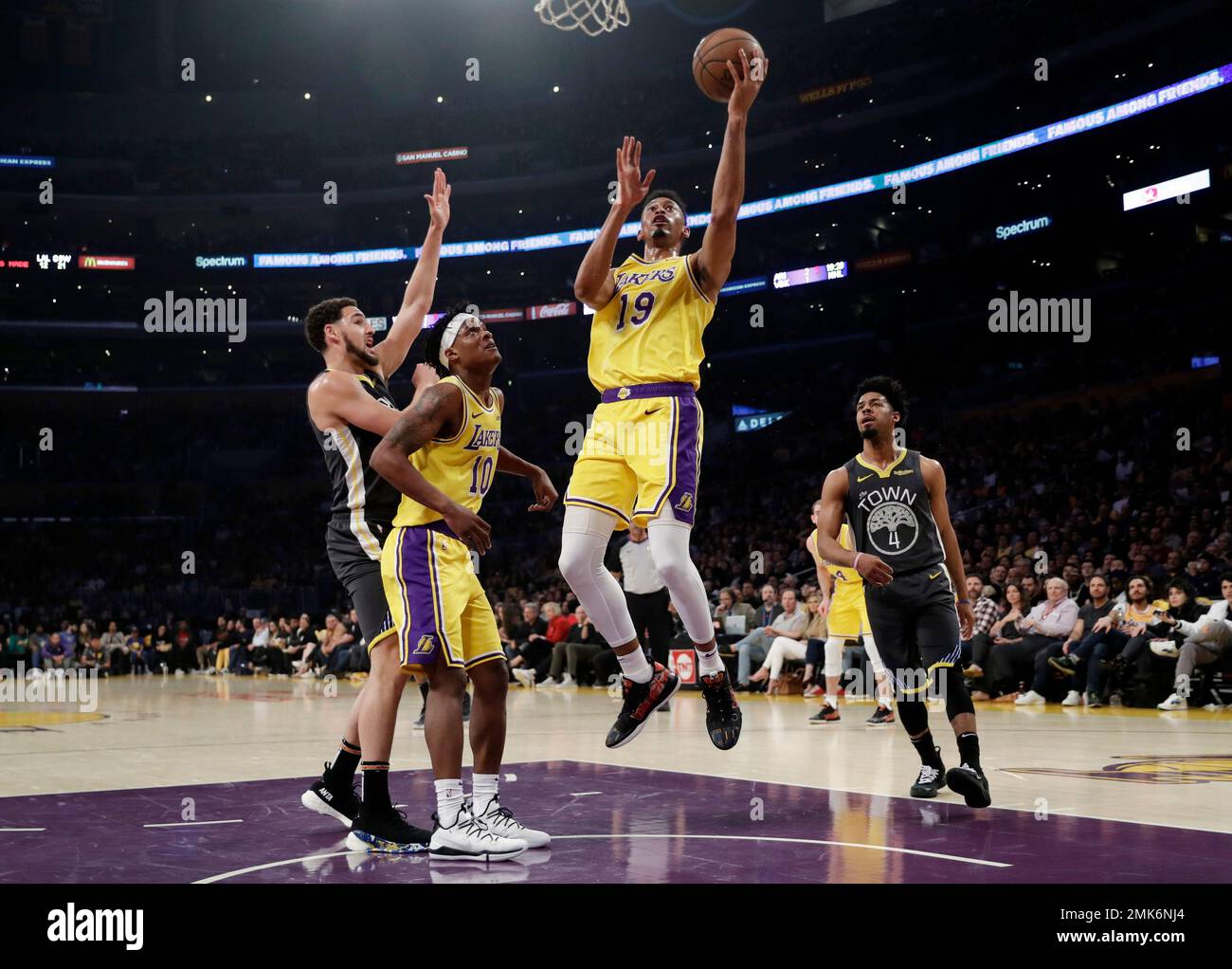 Los Angeles Lakers' Johnathan Williams (19) drives to the basket against  the Golden State Warriors during the first half of an NBA basketball game  Thursday, April 4, 2019, in Los Angeles. (AP