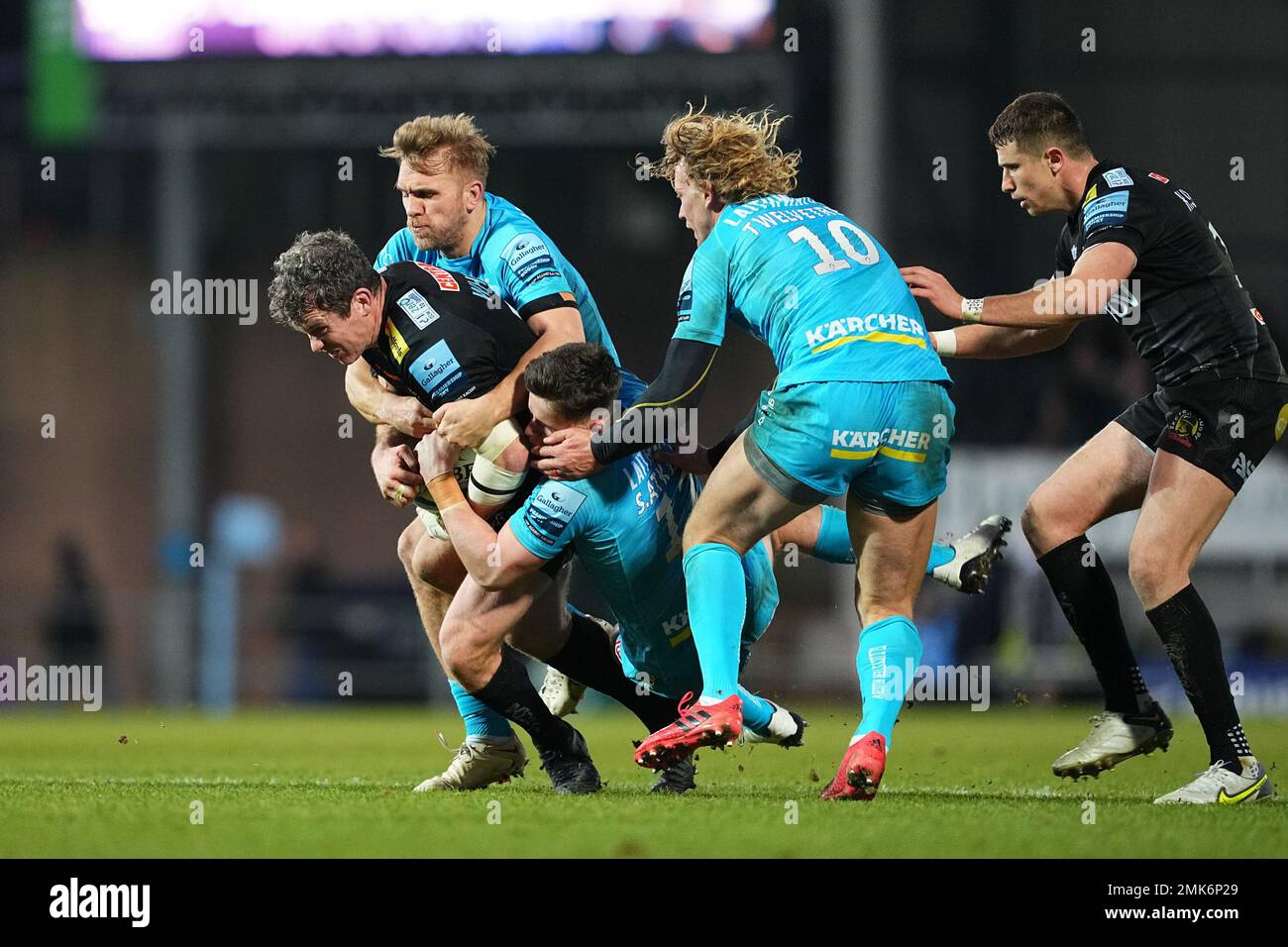 Exeter, UK. 28 January 2023. Ian Whitten of Exeter Chiefs gets tackled by Billy Twelvetrees of Gloucester Rugby, Harry Elrington of Gloucester Rugby and Chris Harris of Gloucester Rugby during the Gallagher Premiership Rugby match between Exeter Chiefs and Gloucester at Sandy Park, Exeter, UK on 28 January 2023. Photo by Scott Boulton. Editorial use only, license required for commercial use. No use in betting, games or a single club/league/player publications. Credit: UK Sports Pics Ltd/Alamy Live News Stock Photo