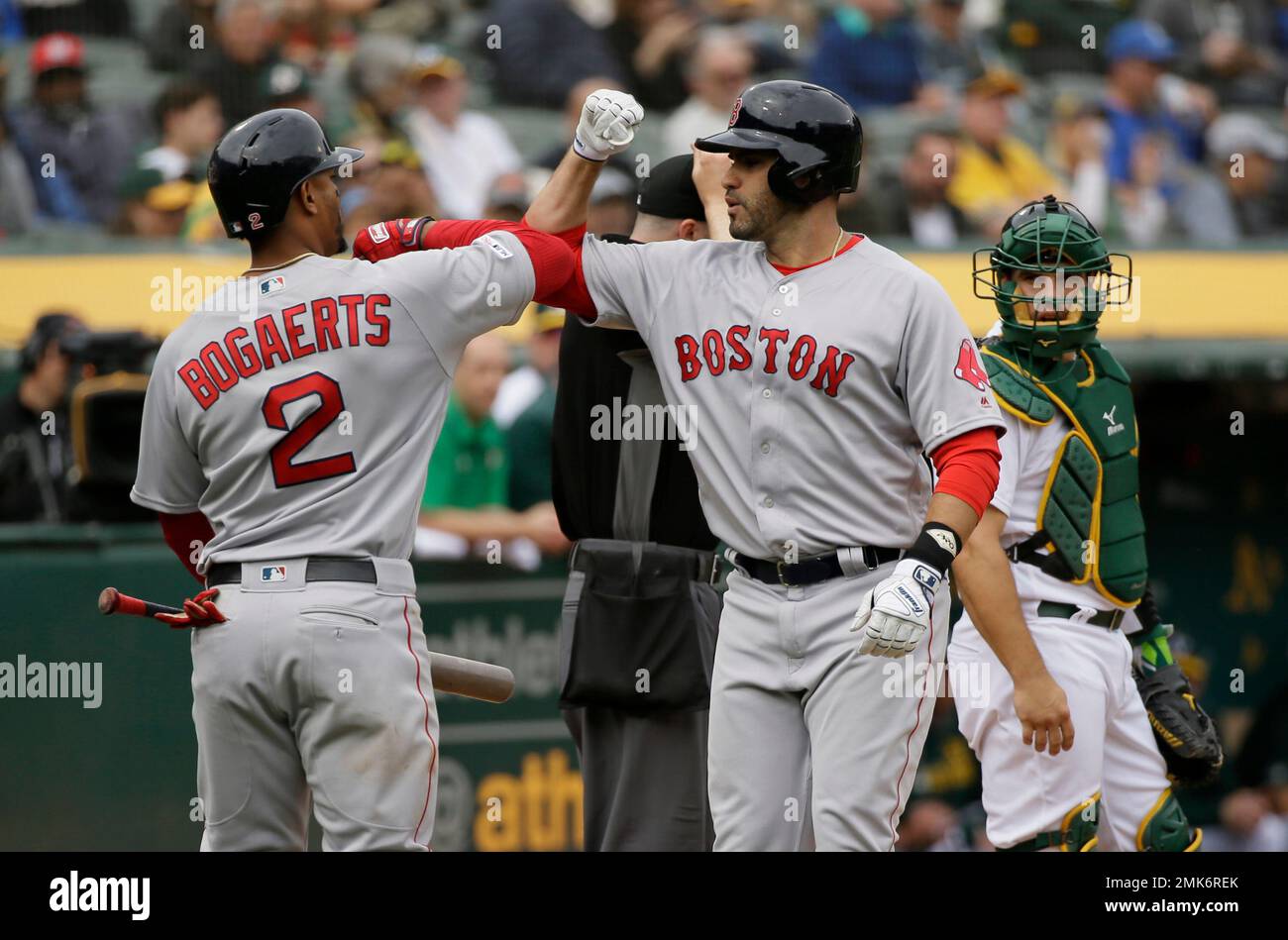 Boston Red Sox's J.D. Martinez, right, is greeted by Xander