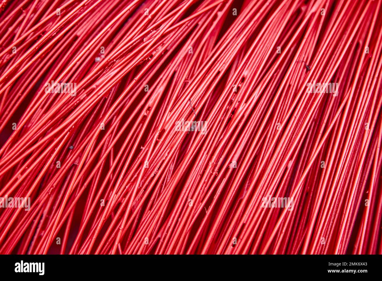 Bright red plastic wire as a background. Beautiful textured surface. Stock Photo