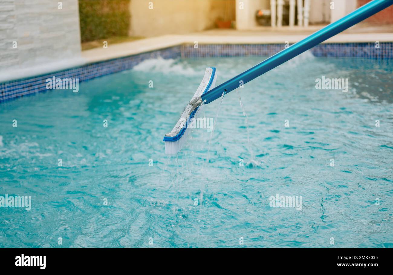 Swimming pool cleaning with brush. Pool brush for wall cleaning, Worker