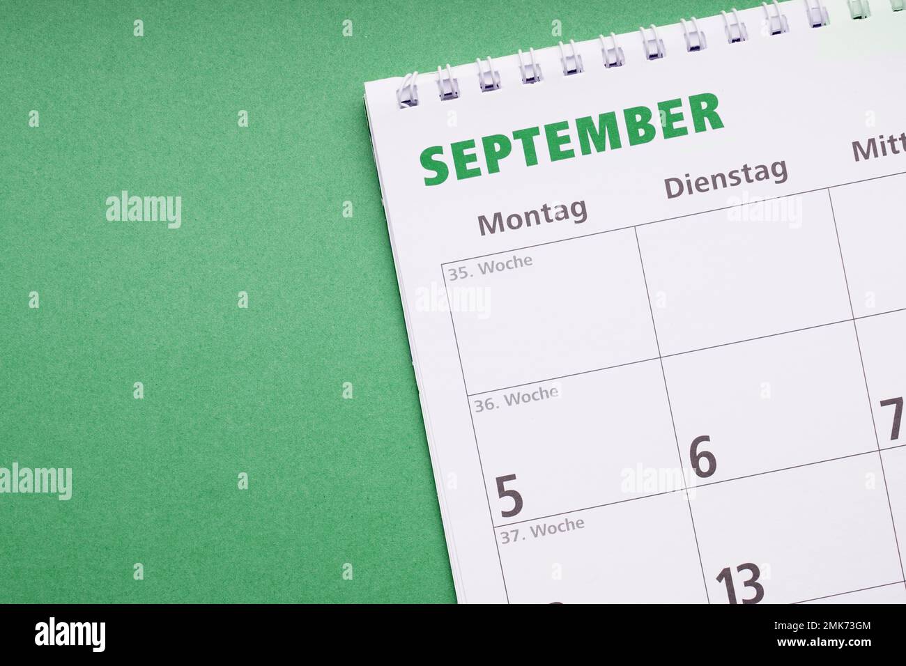 german calendar or planner for the month of september on green paper background with copyspace Stock Photo