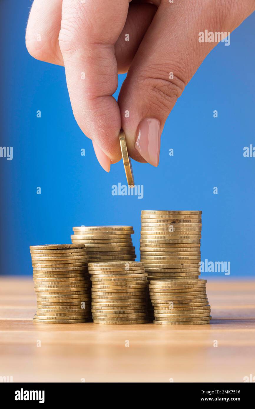 person placing coin pile coins. High resolution photo Stock Photo