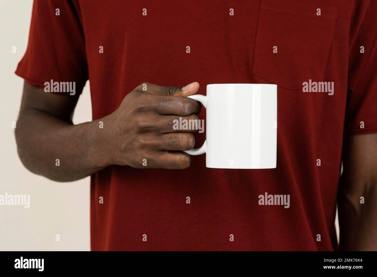 front view man t shirt holding mug. High resolution photo Stock Photo
