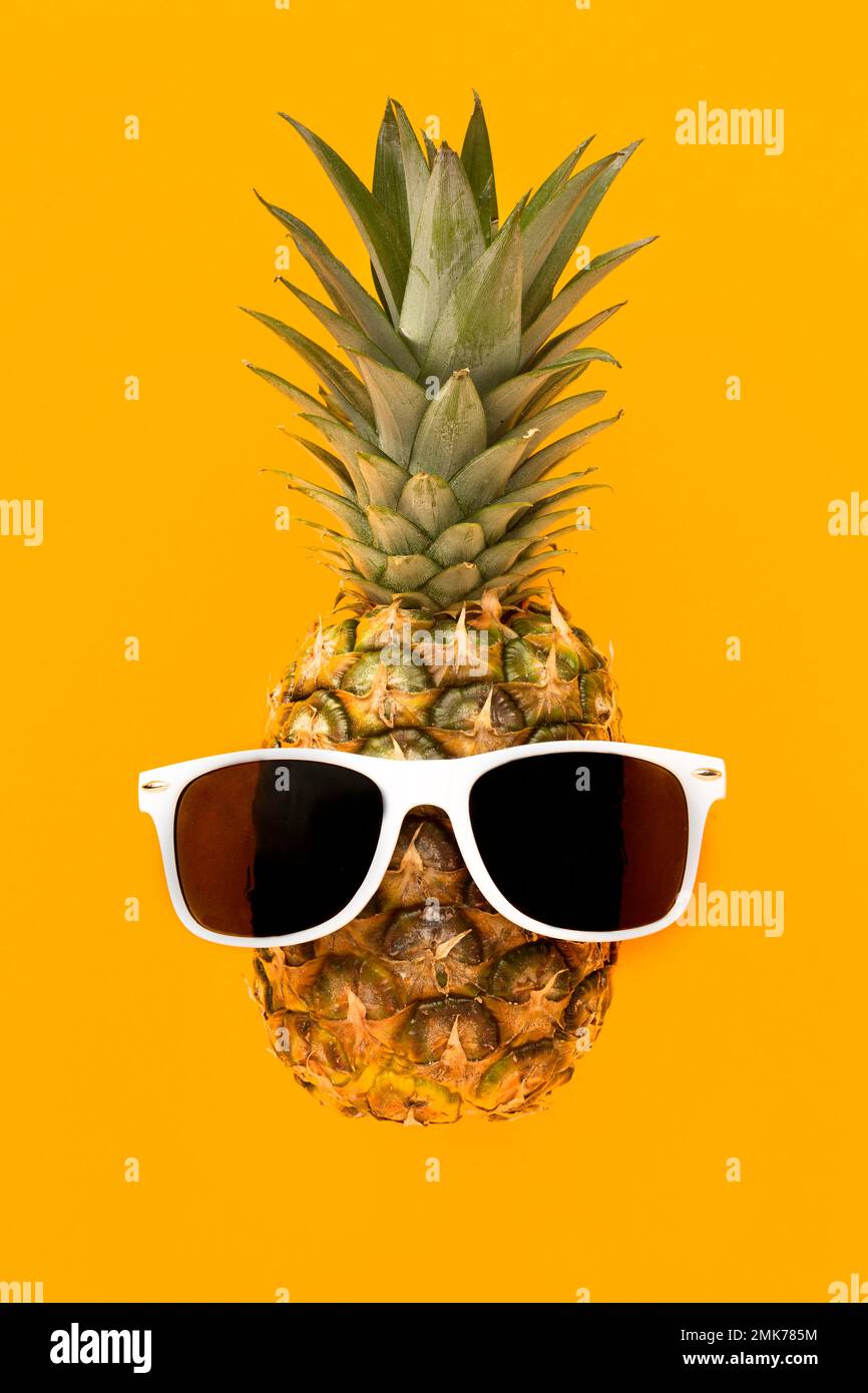 top view exotic pineapple with sunglasses. High resolution photo Stock