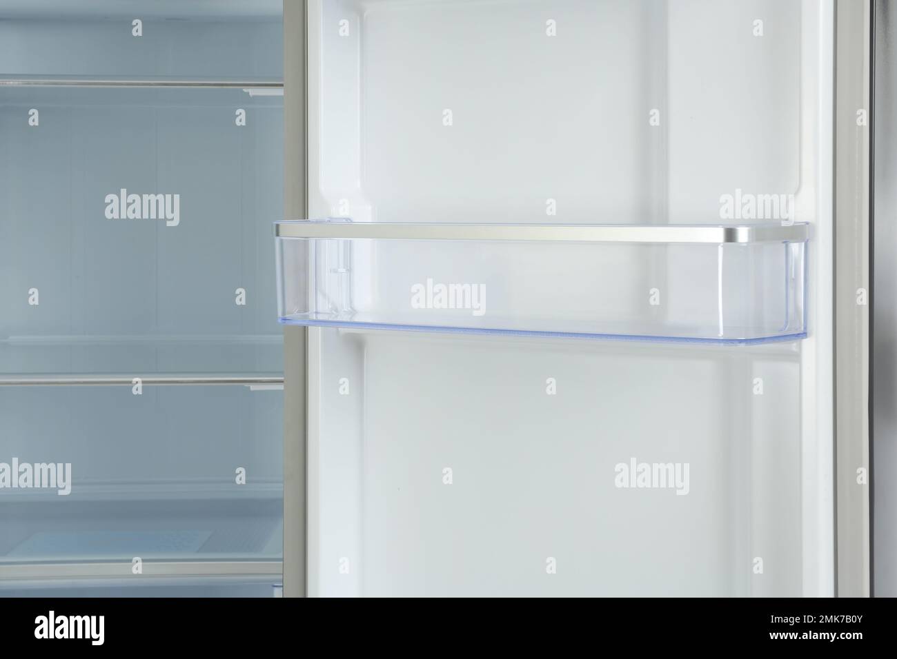 Door shelf of empty modern refrigerator, closeup view Stock Photo