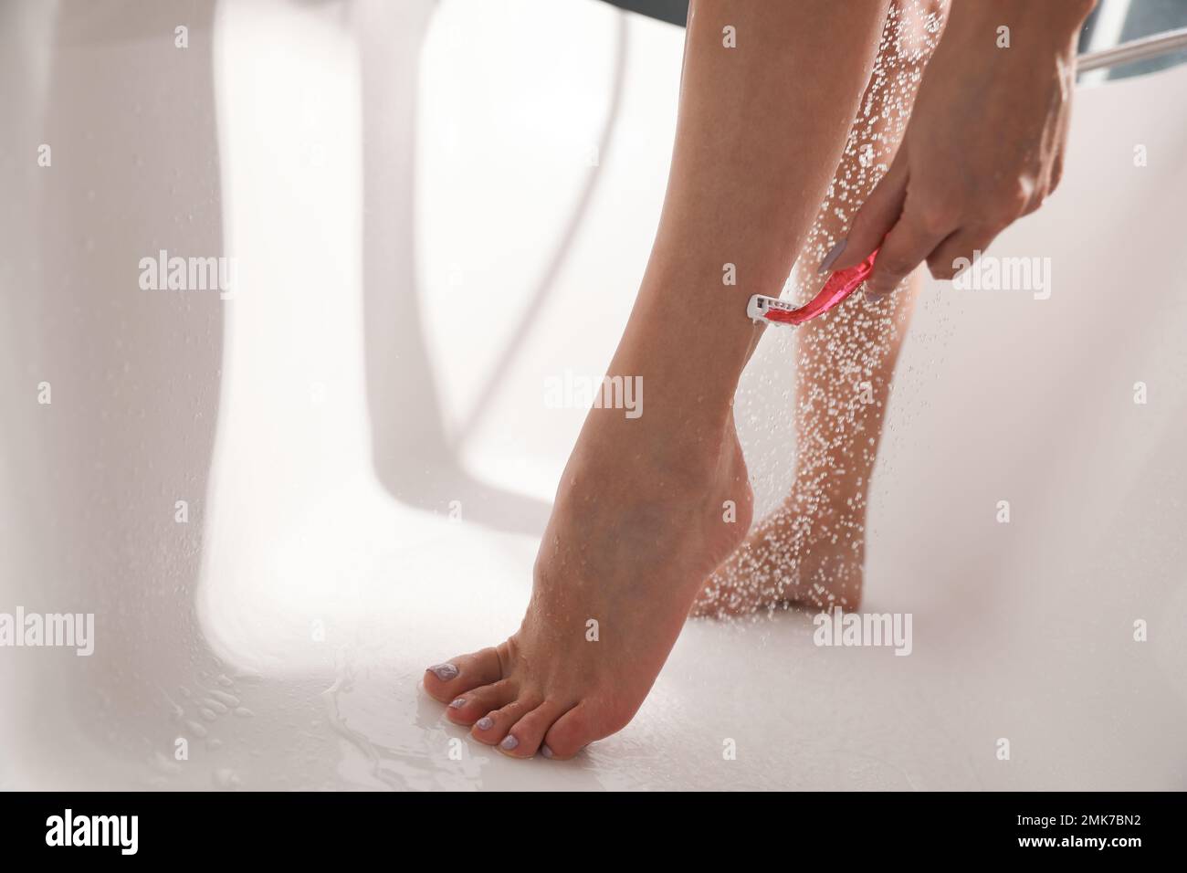 Woman shaving legs in bath hires stock photography and images Alamy
