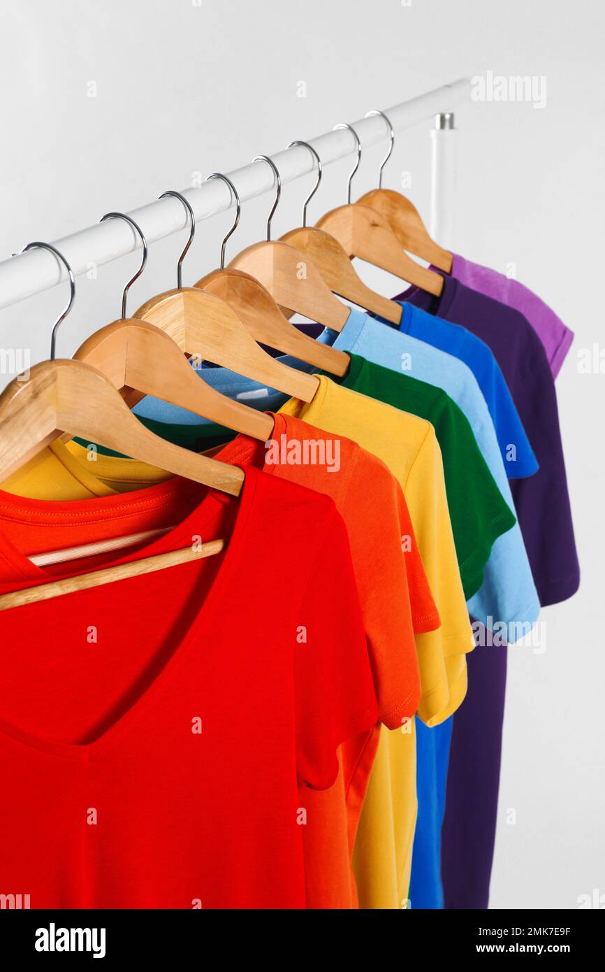 Colorful clothes on hangers against white background Stock Photo