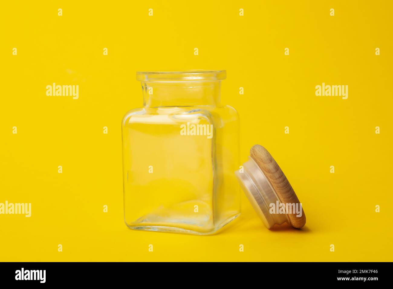 https://c8.alamy.com/comp/2MK7F46/open-empty-glass-jar-on-yellow-background-2MK7F46.jpg