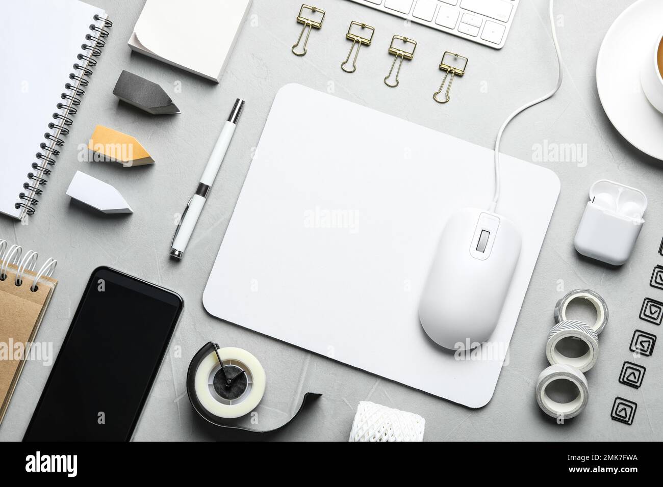 Flat lay composition with wired computer mouse and stationery on light grey table Stock Photo