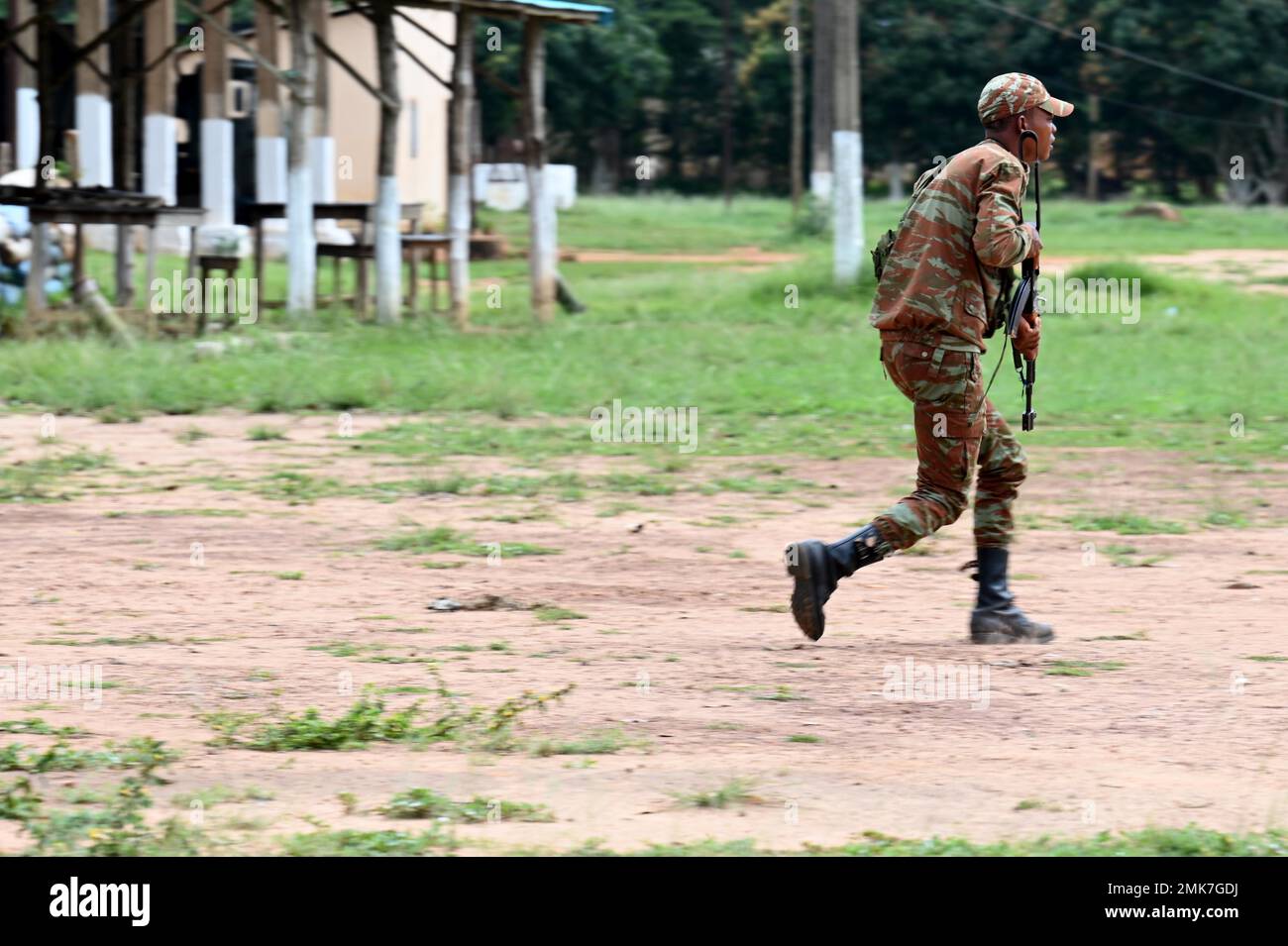 A Beninese soldier from the 1st Commando Parachute Battalion run to a
