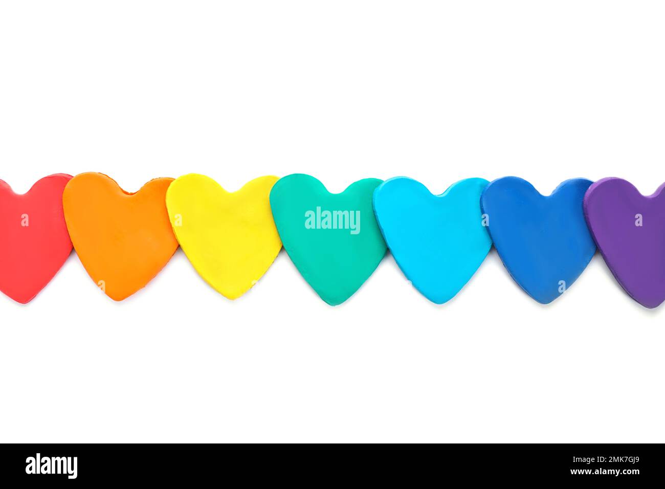 Colorful hearts made of modeling clay on white background, top view. Rainbow palette Stock Photo