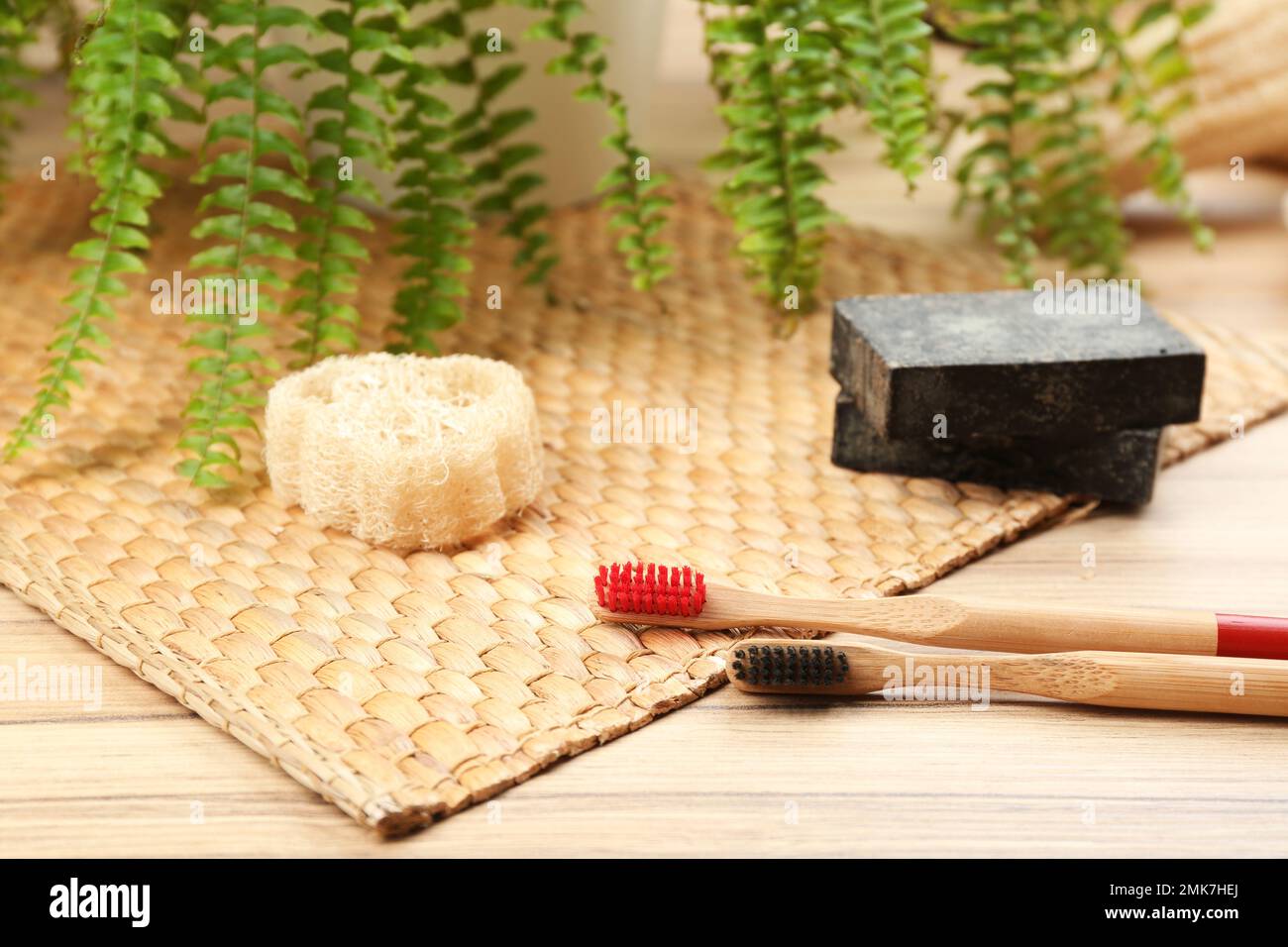 Natural toothbrushes made with bamboo on wooden table Stock Photo