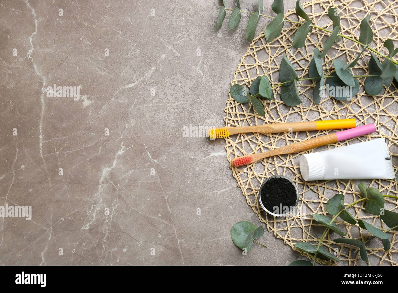 Flat lay composition with bamboo toothbrushes on grey marble table ...
