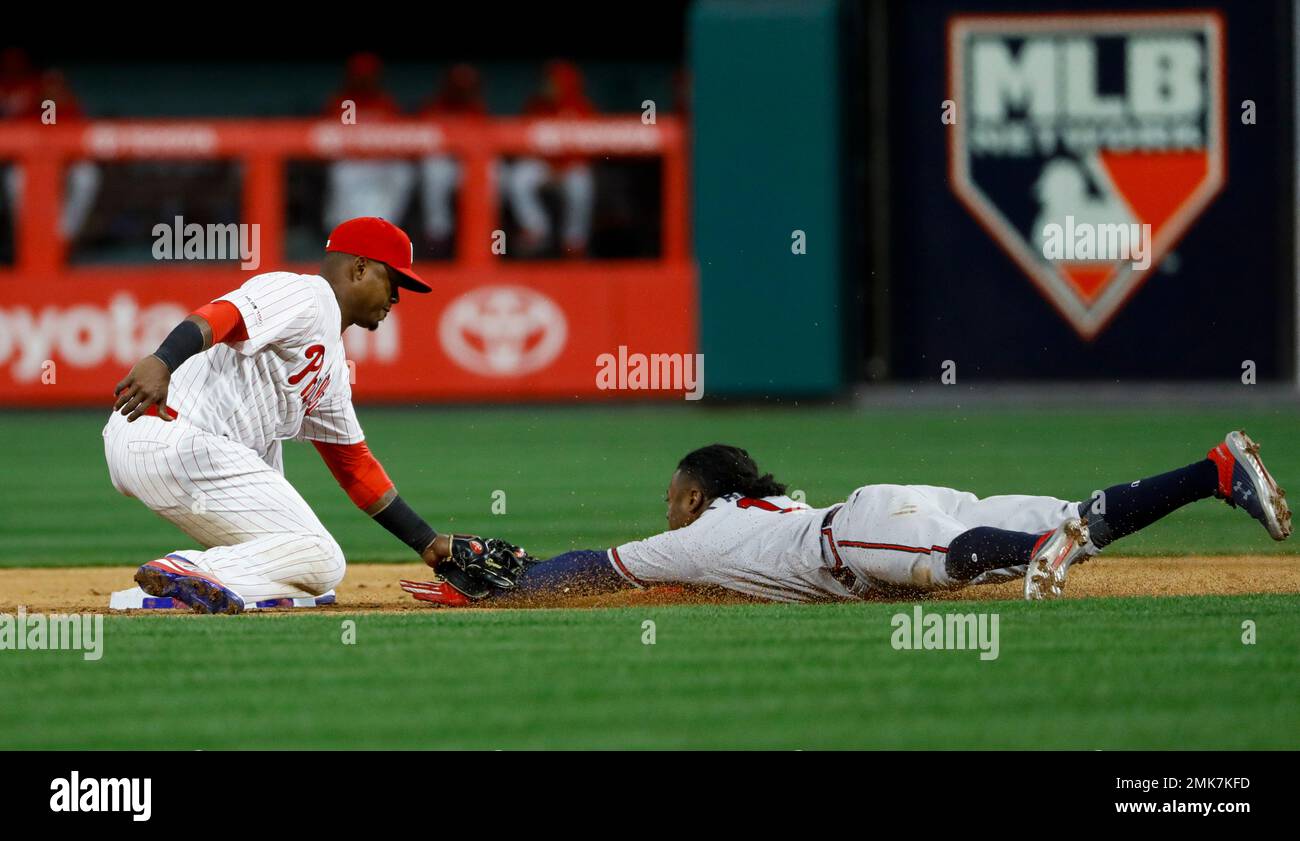 Ozzie Albies pushes Jean Segura hand off base