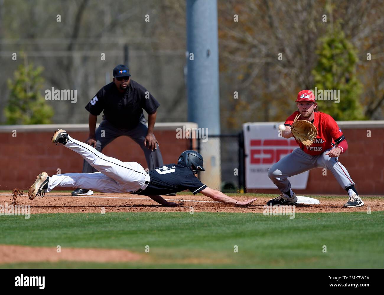 USC Upstate's Garrett Wallace dives back to first base while Gardner-Webb's Corey Howard waits on the ball during an NCAA college baseball game Gardner-Webb, March 30, 2019, in Spartanburg, S.C. (