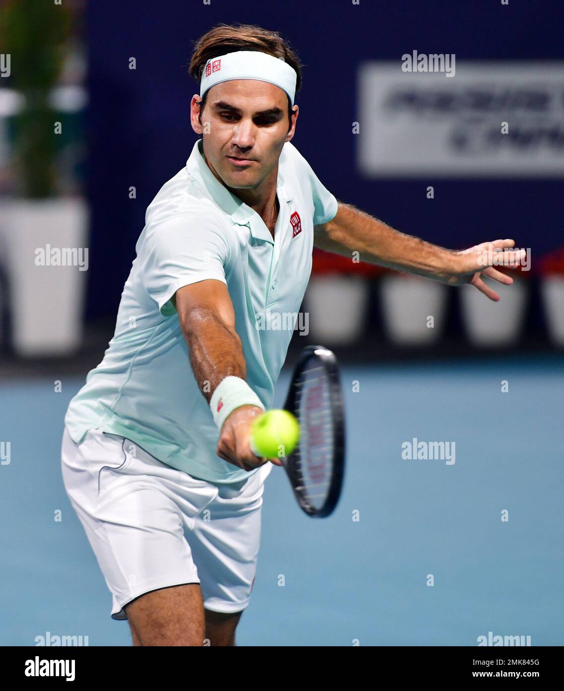 Roger Federer, of Switzerland, hits a backhand to Denis Shapovalov, of  Canada, during the semifinals of Miami Open tennis tournament Friday, March  29, 2019, in Miami Gardens, Fla. (AP Photo/Jim Rassol Stock