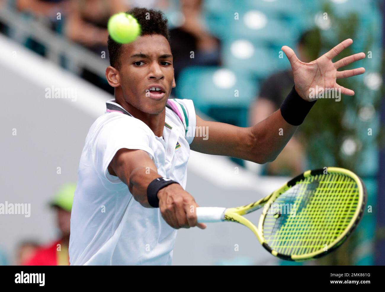Felix Auger-Aliassime, of Canada, returns to John Isner during their  semifinal match at the Miami Open tennis tournament, Friday, March 29,  2019, in Miami Gardens, Fla. (AP Photo/Lynne Sladky Stock Photo -