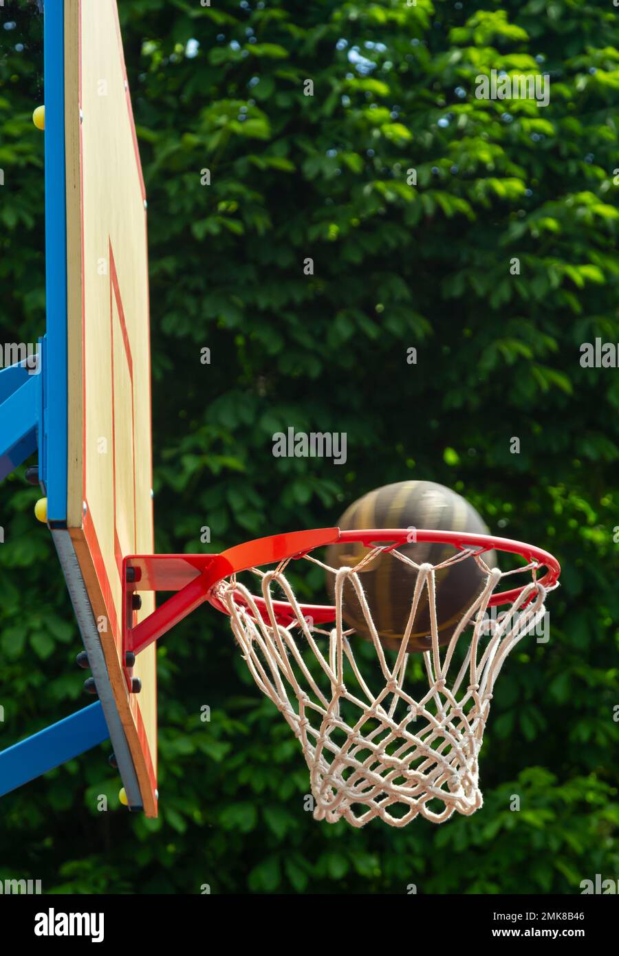 A basketball in the net. The fly ball is in the ring. A sports game