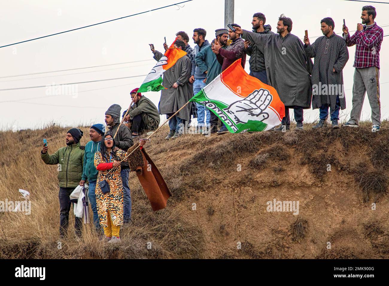 January 27, 2023, Srinagar, Jammu and Kashmir, India: Supporters of Indian Congress Leader Rahul Gandhi waves party flags during the ''Bharat Jodo Yatra'' or (Unite March India) in Anantnag South Kashmir. The march is an ongoing mass movement, began on 7th September, 2022 organized by the Indian National Congress (a major political party in India) led by party leader Rahul Gandhi who along with his supporters, part of his five month long (3,570km) (2,218 mile) over 150 days countrywide foot march through 12 states from Kanyakumari in Southern India to Kashmir in North India. The march is joine Stock Photo