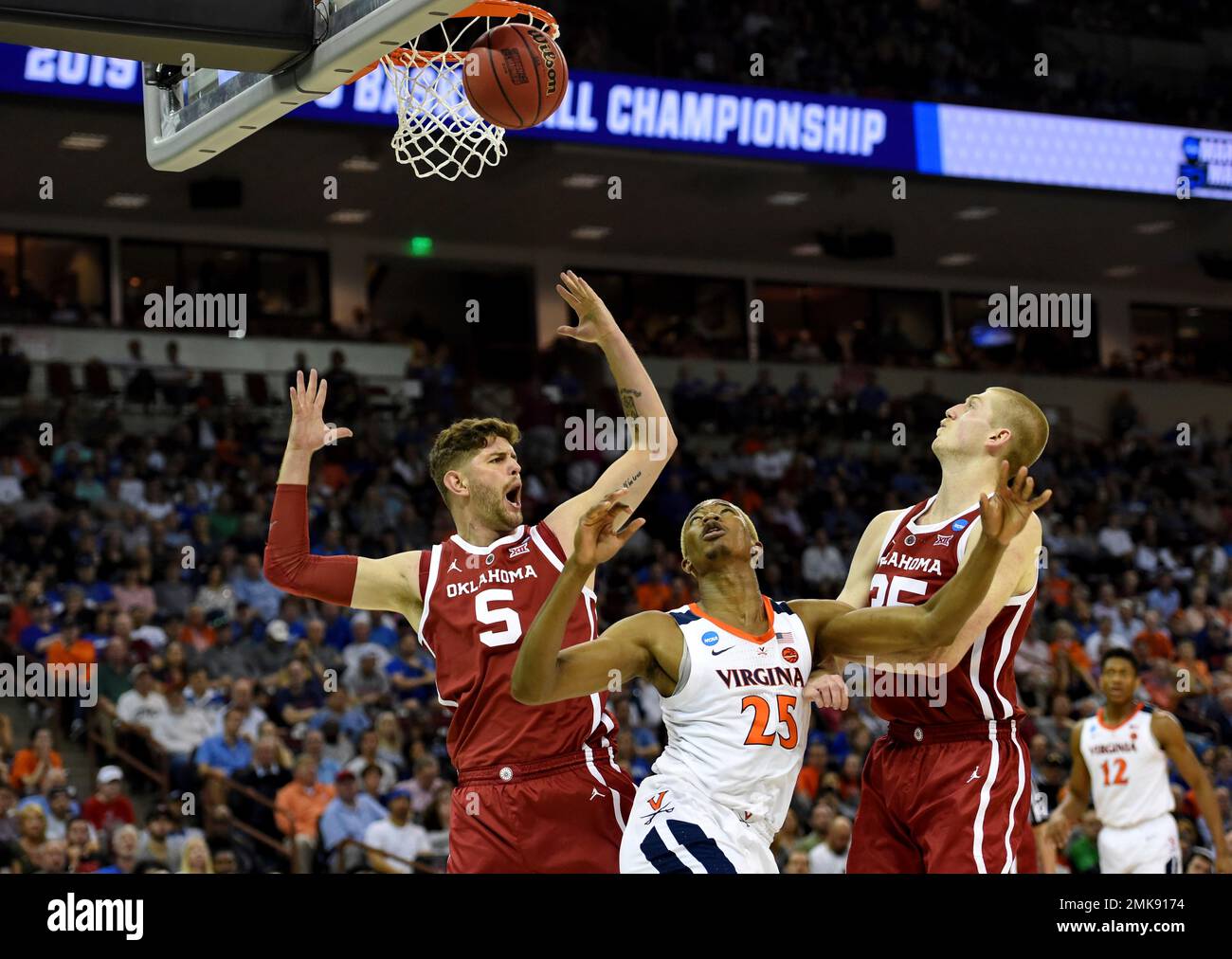 Virginia's Mamadi Diakite (25) after shooting looks for the rebound while  defended by Oklahoma's Matt Freeman (5) and Brady Manek (35) during the  second half of a second round men's college basketball