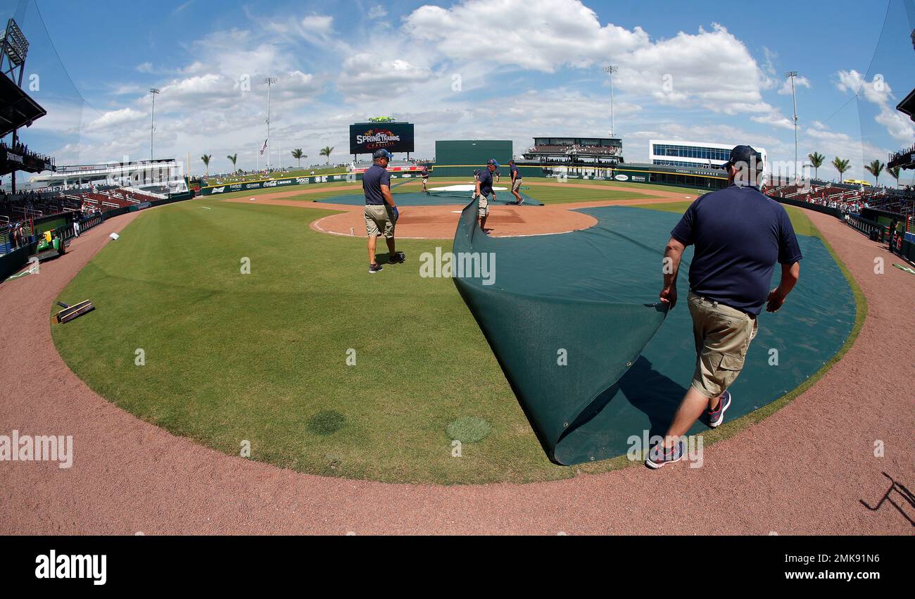 Members of the Atlanta Braves grounds crew work to prepare the field for  the first game played at CoolToday Park, spring training baseball game  between the Braves and the Tampa Bay Rays