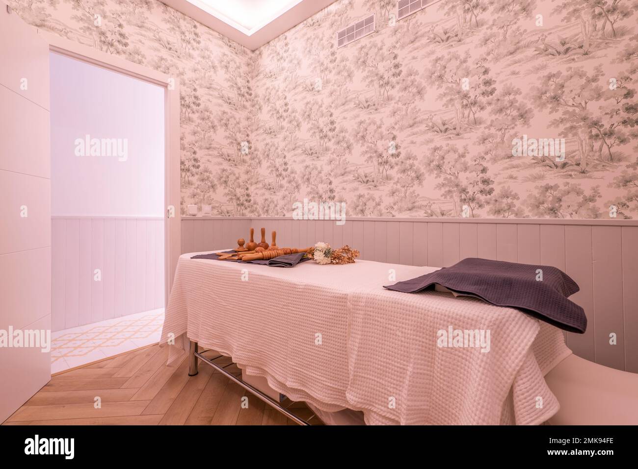 Cabin with massage table with towels and wood therapy utensils and treatments from a beauty salon and aesthetic care Stock Photo