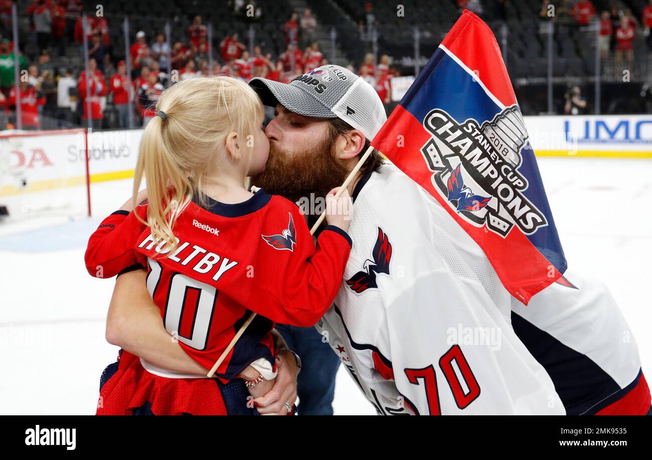 FILE In this June 7 2018 file photo Washington Capitals goaltender Braden Holtby right kisses his daughter Belle after the Capitals defeated the Vegas Golden Knights 4 3 in Game 5 of