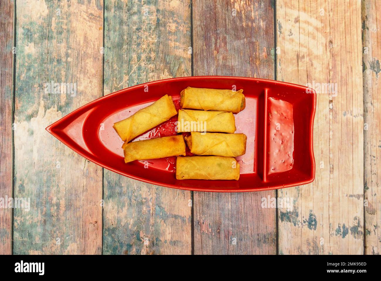 Fried Vietnamese spring rolls on a boat-shaped tray Stock Photo