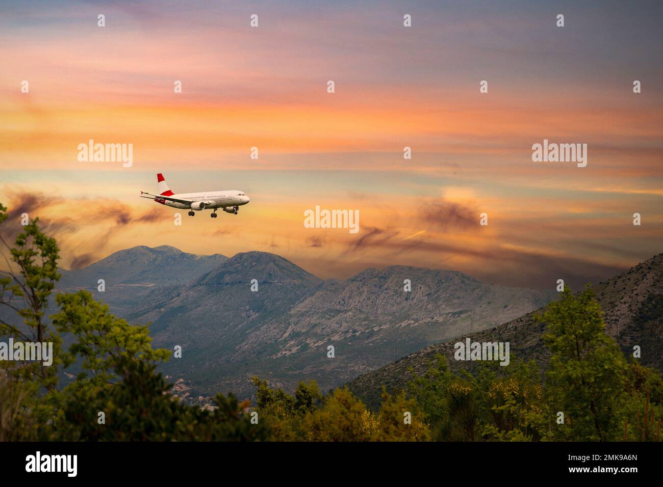 Airplane landing in Dubrovnik airport (Cavtat) on a sunset time. Stock Photo