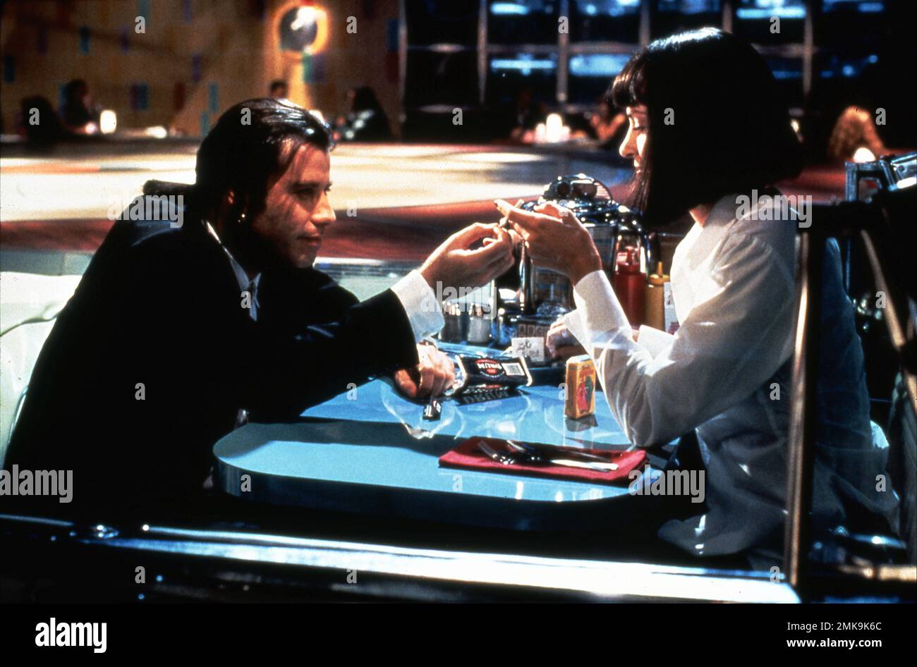 JOHN TRAVOLTA and UMA THURMAN in PULP FICTION 1994 director / writer QUENTIN TARANTINO stories Quentin Tarantino and Roger Avary costume design Betsy Heimann producer Lawrence Bender A Band Apart / Jersey Pictures / Miramax (USA) - Buena Vista International (UK) Stock Photo