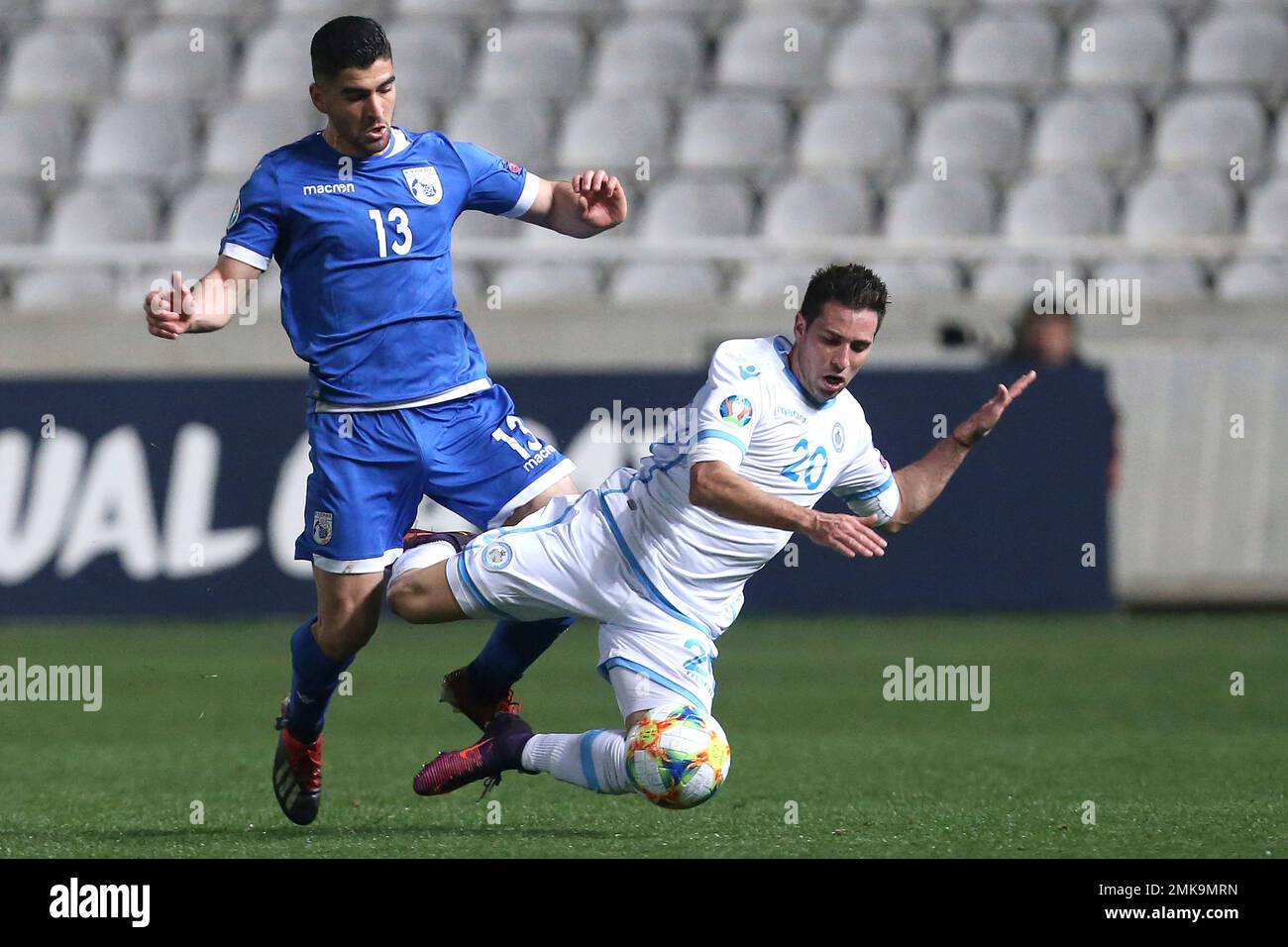 Cyprus' Ioannis Kousoulos, left, fights for the ball with San Marino's Jose  Hirsch during the Euro 2020 group I qualifying soccer match between Cyprus  and San Marino at the GSP stadium in