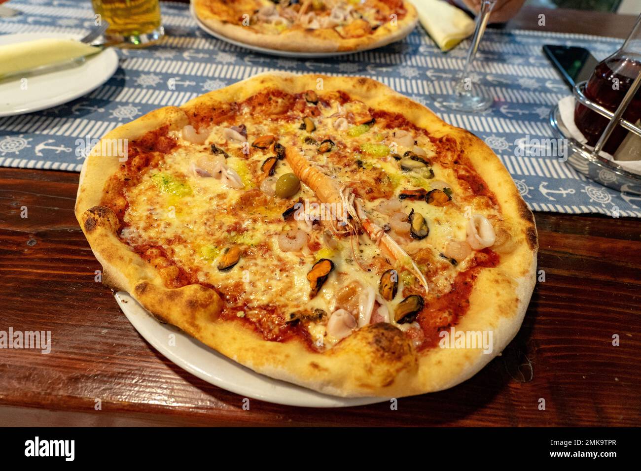 eating seafood frutti di mare pizza in a seafood restaurant in Croatia . Stock Photo
