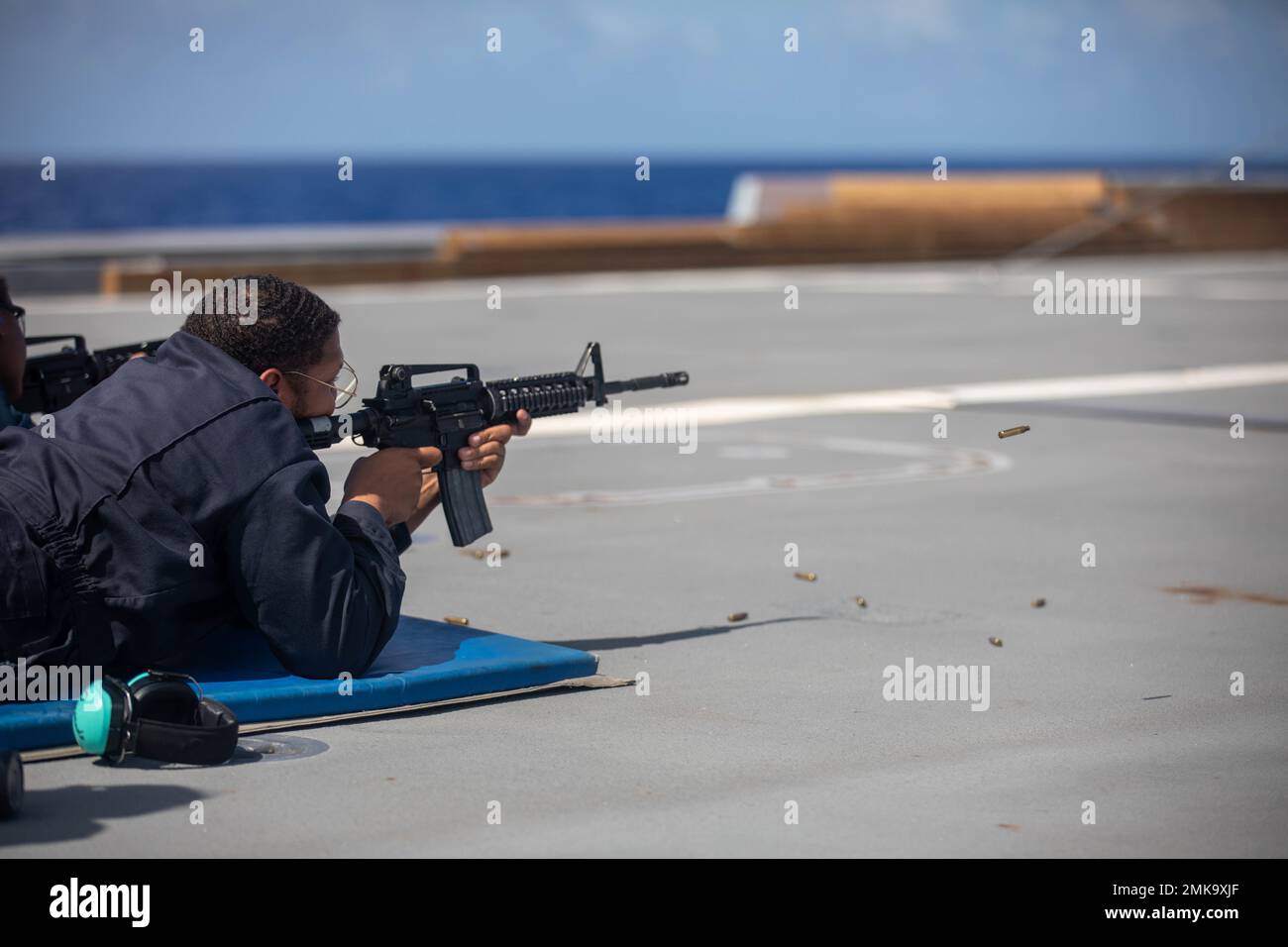 PHILIPPINE SEA (Sept. 7, 2022) – Operations Specialist 1st Class Johndell  Henderson, from Los Angeles, fires an M4 rifle during a gun shoot aboard  guided-missile destroyer USS Zumwalt (DDG 1000) in the