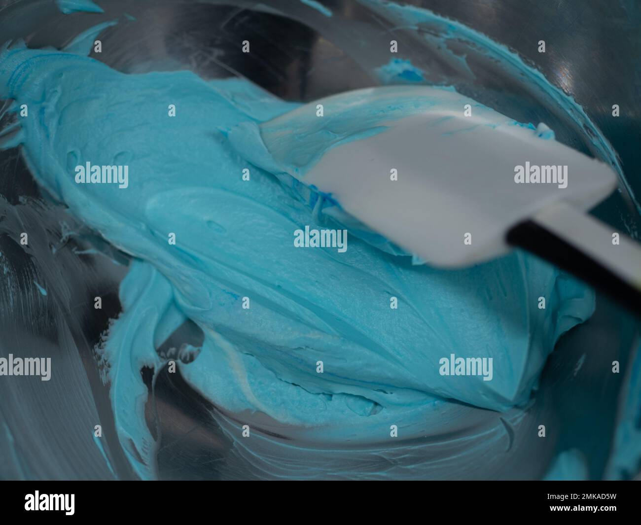 turquoise icing piping filling for frosted cake decoration in kitchen