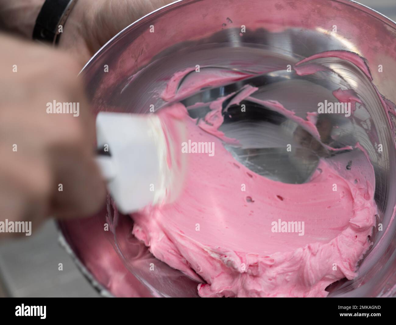 pink icing piping filling for frosted cake decoration in kitchen lab