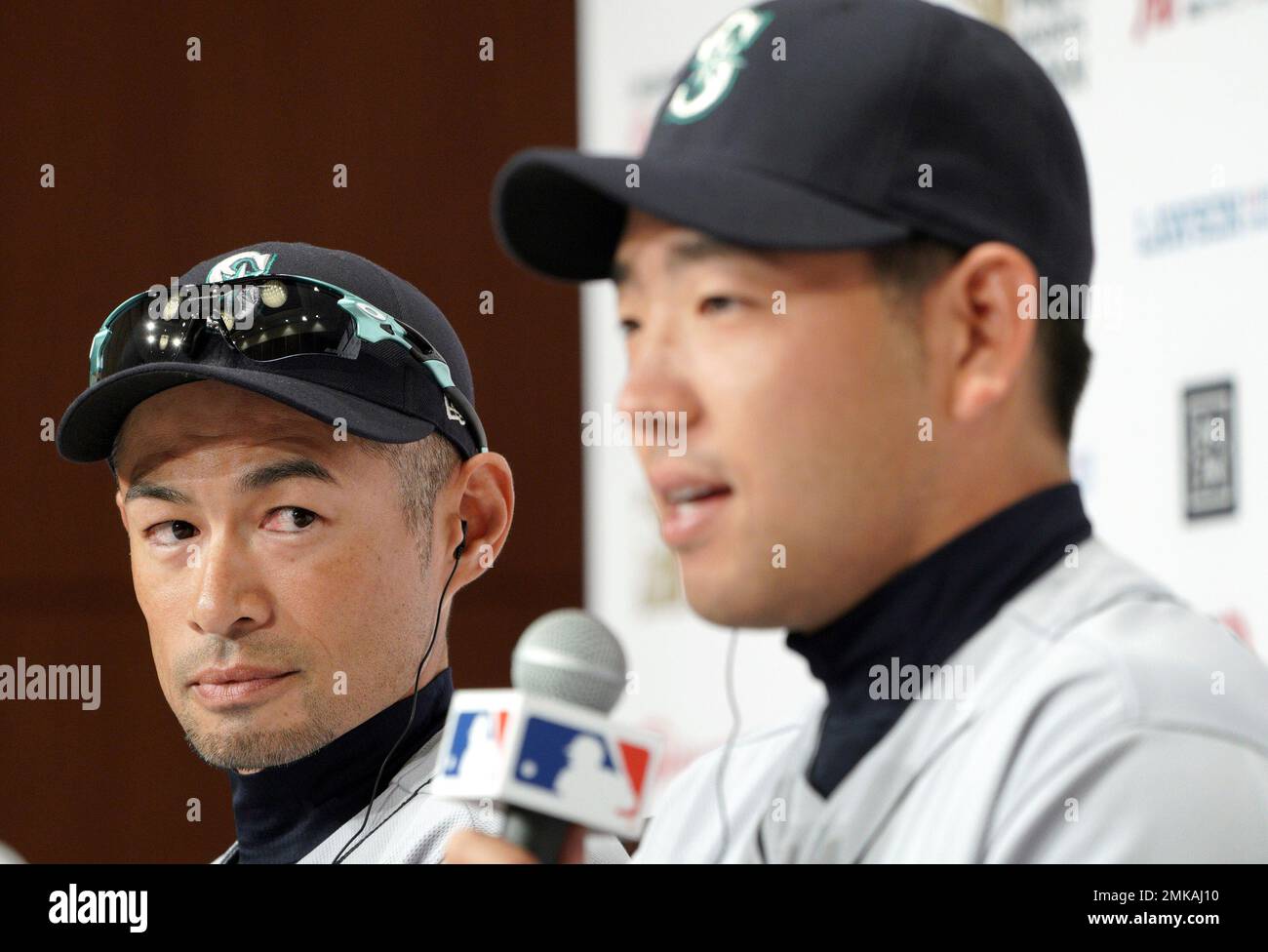 Seattle Mariners' Yusei Kikuchi (L) and Ichiro Suzuki talk during