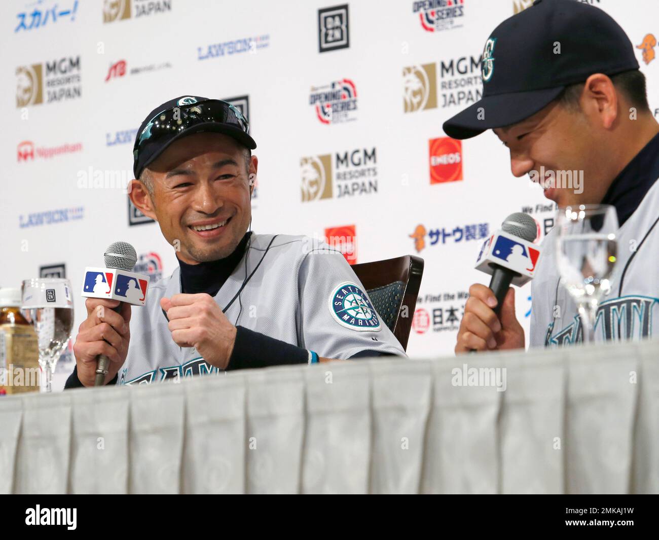 Seattle Mariners' Yusei Kikuchi (L) and Ichiro Suzuki talk during