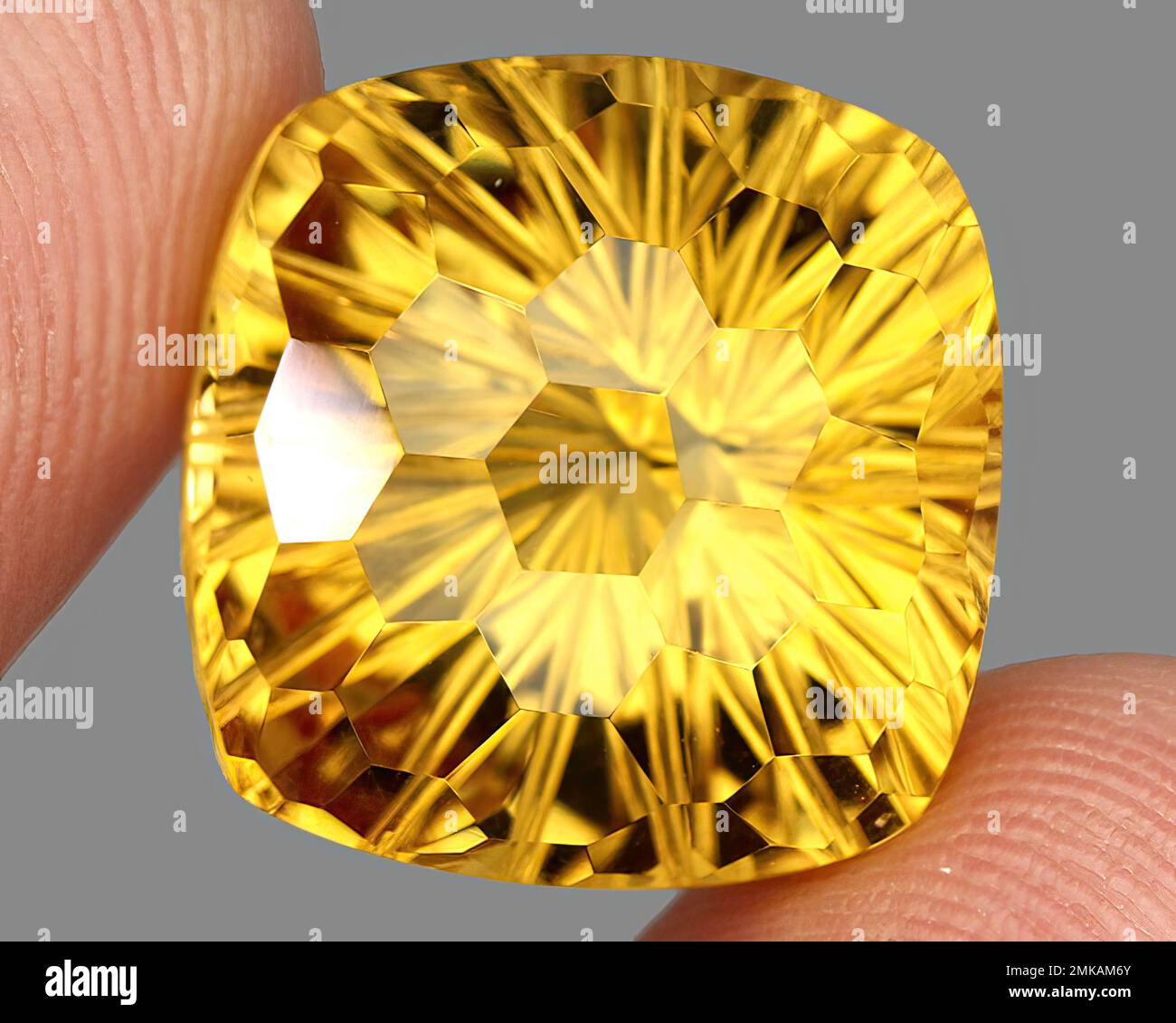 Natural gem yellow citrine on gray background Stock Photo
