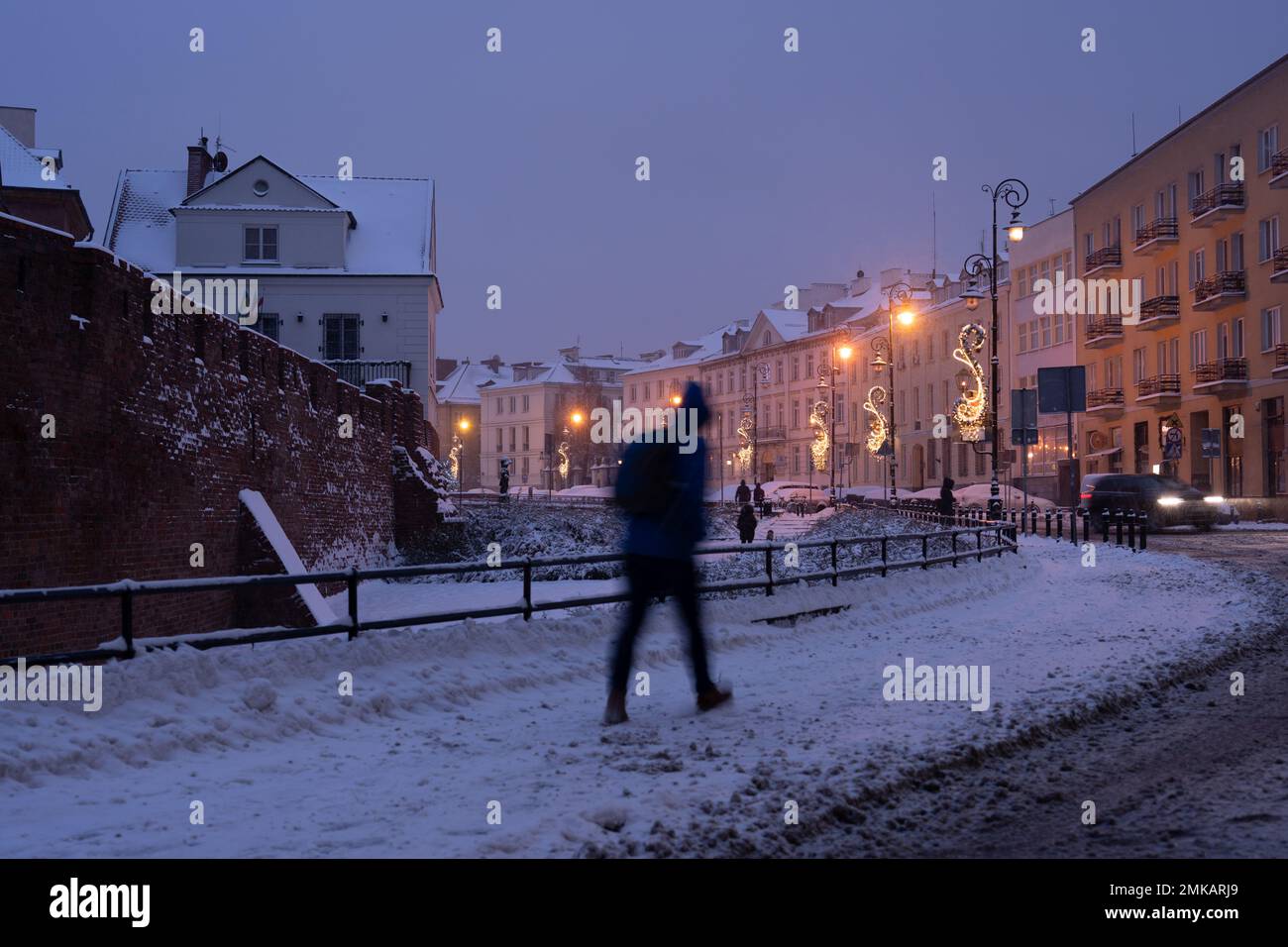 People walking the snowed streets of Warshaw during the holiday seasons Stock Photo