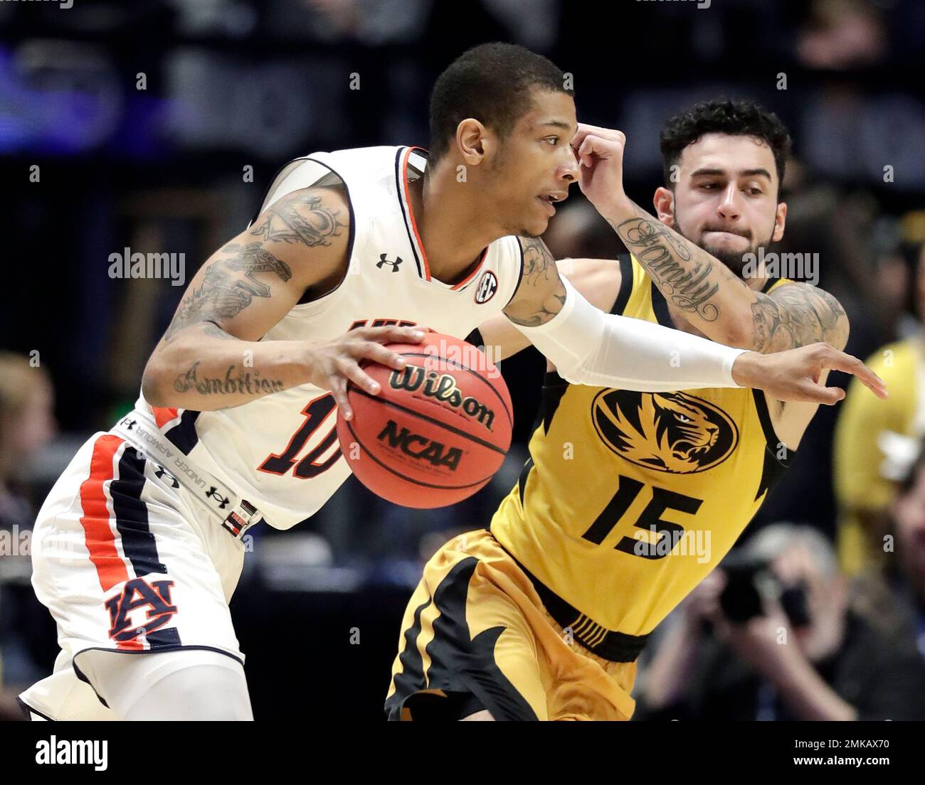 Auburn guard Samir Doughty (10) drives against Missouri guard Jordan Geist  (15) in the first half of an NCAA college basketball game at the  Southeastern Conference tournament Thursday, March 14, 2019, in