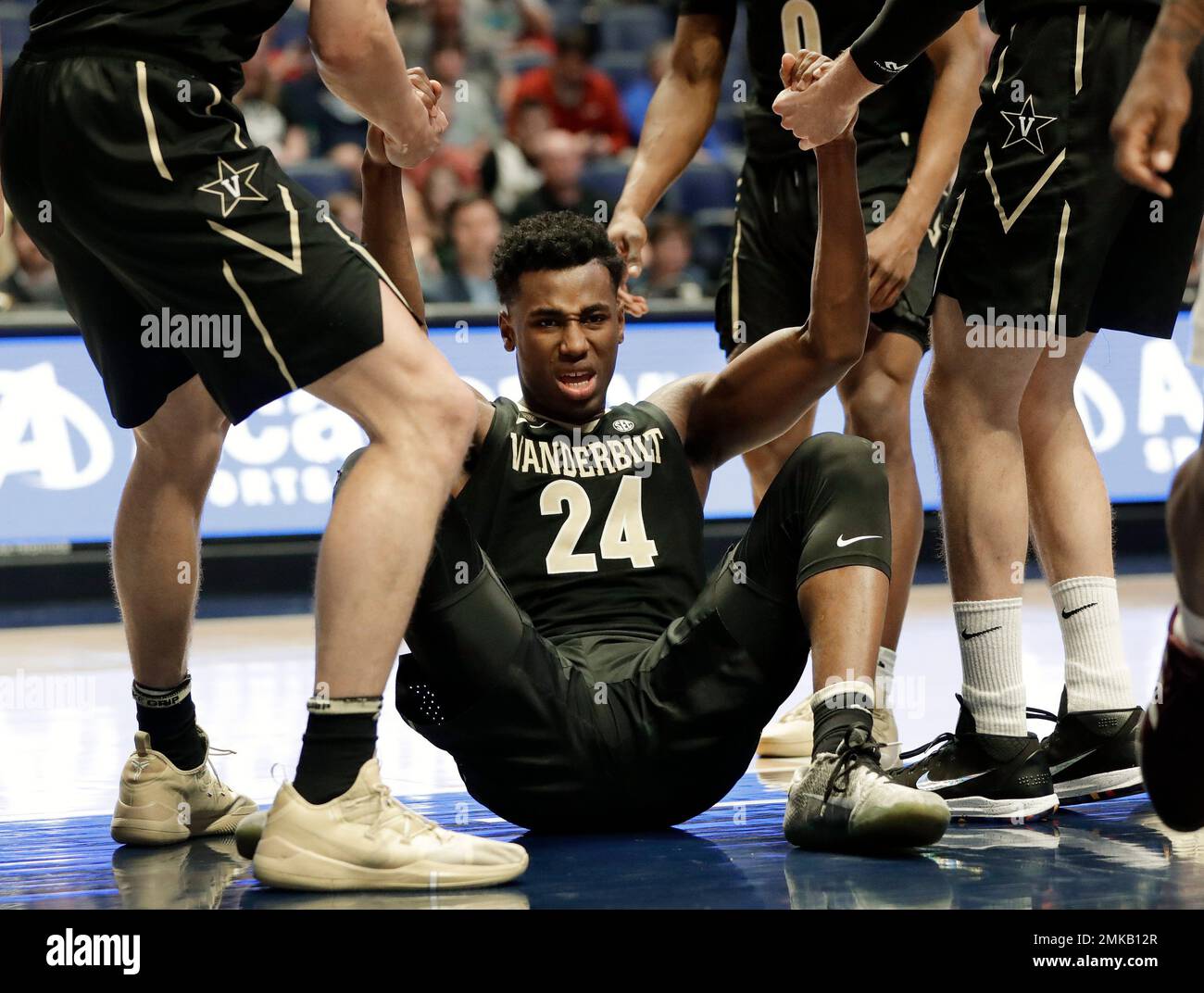 Vanderbilt forward Aaron Nesmith (24) is helped up in the second half of an  NCAA college basketball game against Texas A&M at the Southeastern  Conference tournament Wednesday, March 13, 2019, in Nashville